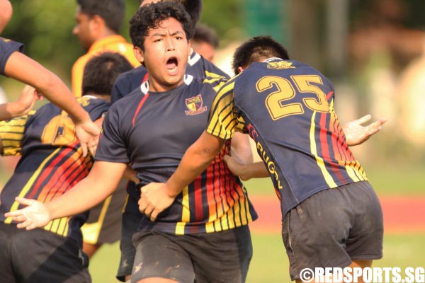 Ahmad Zhuri (ACS #13) elated and celebrating after he scored the try.