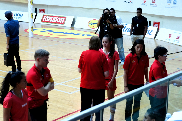Coach Ruth speaks with Team Captain Lin Qinyi