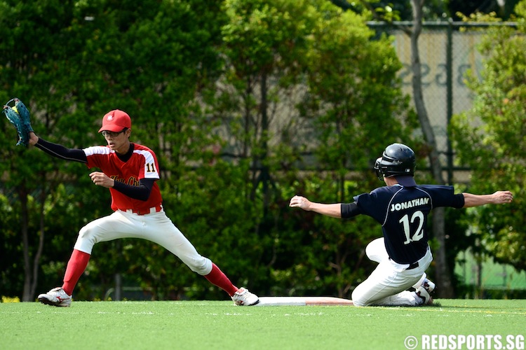 Jonathan (ACSI #12) slides into first base. (Photo 5 © Matthew Lau/Red Sports)