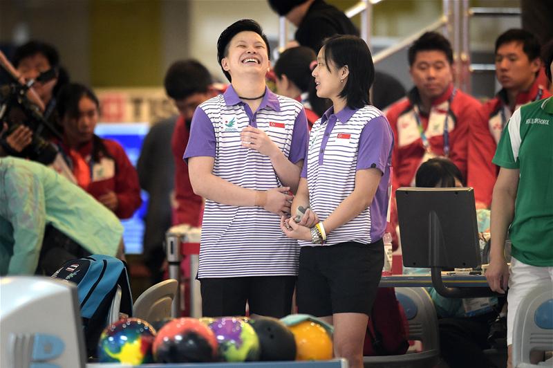 New Hui Fen (left) and Jazreel Tan share a laugh between frames during the women's doubles final. They placed fourth with 2447 pinfalls, narrowly missing out on bronze by 15. It was Hui Fen's second fourth-place finish at the Asiad after the women's singles, in which Jazreel had won silver. (Photo 4 courtesy of Joseph Nair/Sport Singapore via Action Images Livepic)