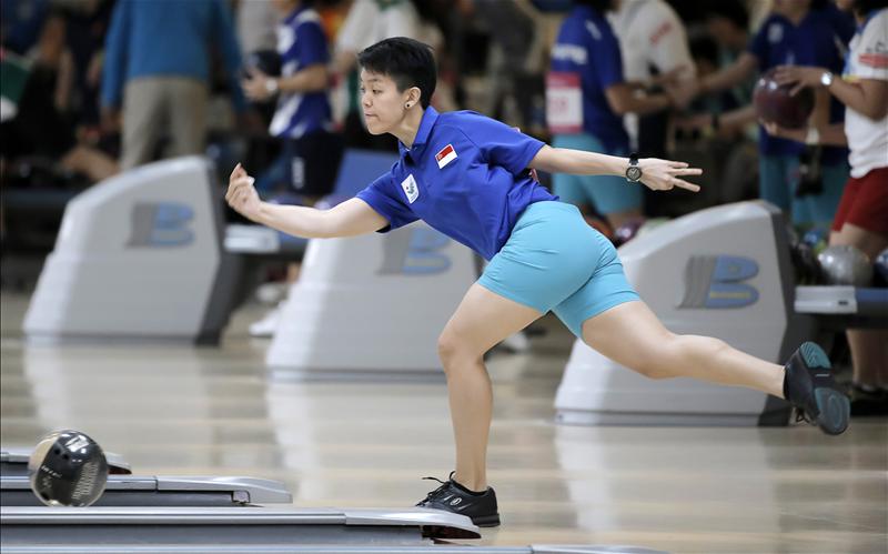 Singapore's female keglers could hit gold tomorrow in the women's team of five event after taking the lead today in the first block of three games, led by the renewed form of 2012 World Cup champion, Shayna Ng (seen here in action during the women's trios competition yesterday). (Photo 2 courtesy of Vivek Prakash/Sport Singapore via Action Images Livepic)