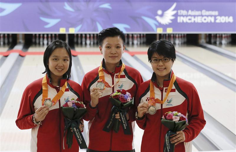 The team of (from left) Jazreel Tan, New Huifen, and Cherie Tan won silver in the women's trios event. It was Jazreel's and Singapore's second silver in bowling at the Asiad. (Photo 3 courtesy of Vivek Prakash/Sport Singapore via Action Images Livepic)