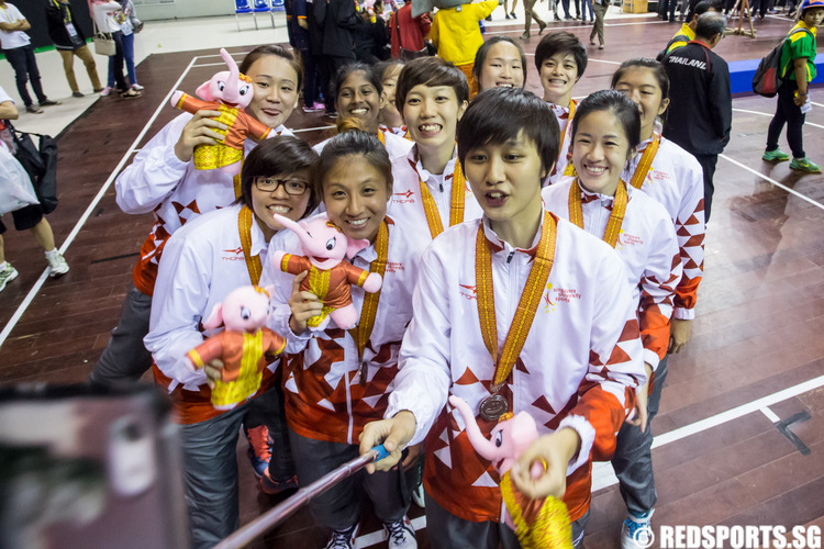 Members of the Singapore women's basketball team pose for a group selfie after the prize presentation of the 17th ASEAN University Games Basketball Championships. (Photo © Lim Yong Teck/Red Sports)