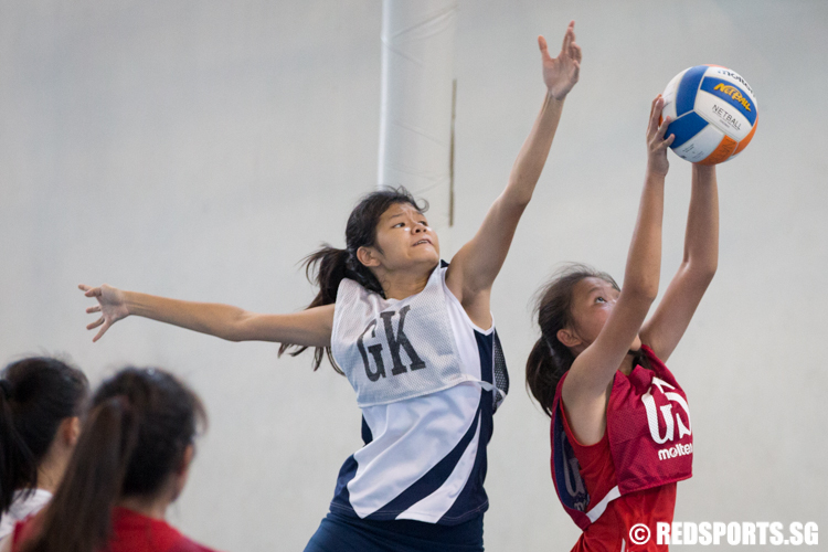 Edna Leong (GK) of CHIJ Secondary Toa Payoh tries to intercept a pass made to Yi Xuan (GS) of River Valley High School.