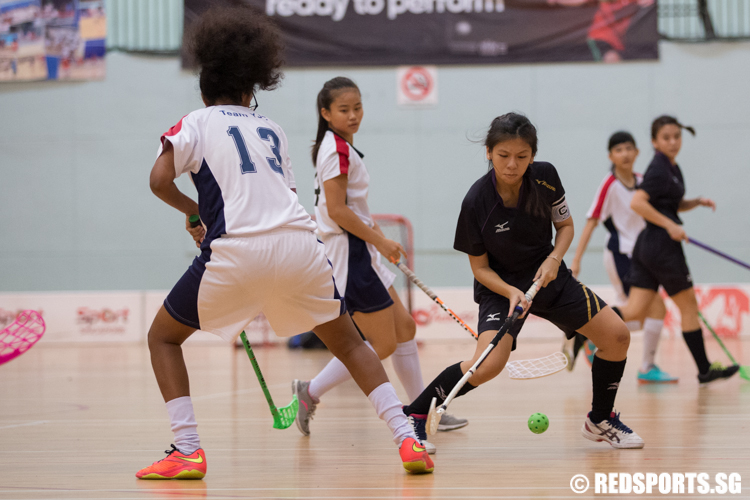 Natalie Tham (#23) of Victoria Junior College and Bharati Buddhamurthy (#13) of Yishun Junior College fight for possession of the ball. (Photo © Lee Jian Wei/Red Sports)