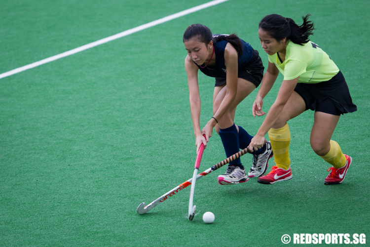 Shannon Leong (#16) of Saint Andrew’s Junior College and Lydia Thio (#11) of Victoria Junior College fights for possession of the ball. (Photo © Lee Jian Wei/Red Sports)