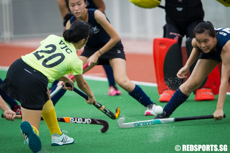Teo Ting Ya (#20) of Victoria Junior College takes a shot against defender Xena Ngoo (#18) of Saint Andrew’s Junior College. (Photo © Lee Jian Wei/Red Sports)
