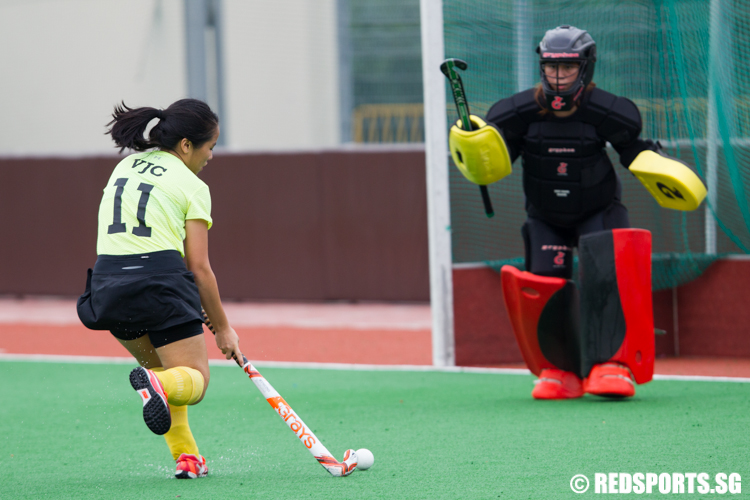 Lydia Thio (#11) of Victoria Junior College goes against the goalkeeper of Saint Andrew’s Junior College. (Photo © Lee Jian Wei/Red Sports)