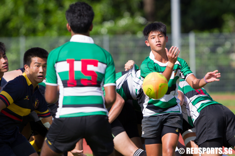 Isaac Goh (#9) of Raffles Institution passes the ball to his teammate from the scrum. (Photo © Lee Jian Wei/Red Sports)