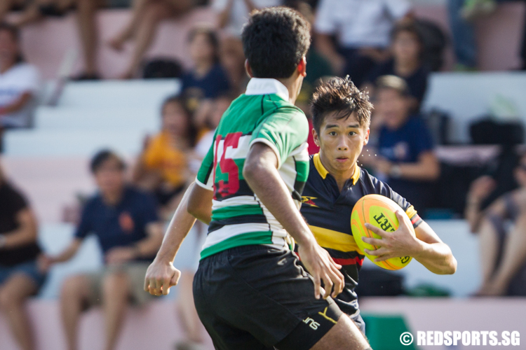 Brandon Nathanael Beng (#11) of Anglo-Chinese Junior College goes against Harish Rai (#15) of Raffles Institution. went on to score a try for Anglo-Chinese Junior College. (Photo © Lee Jian Wei/Red Sports)