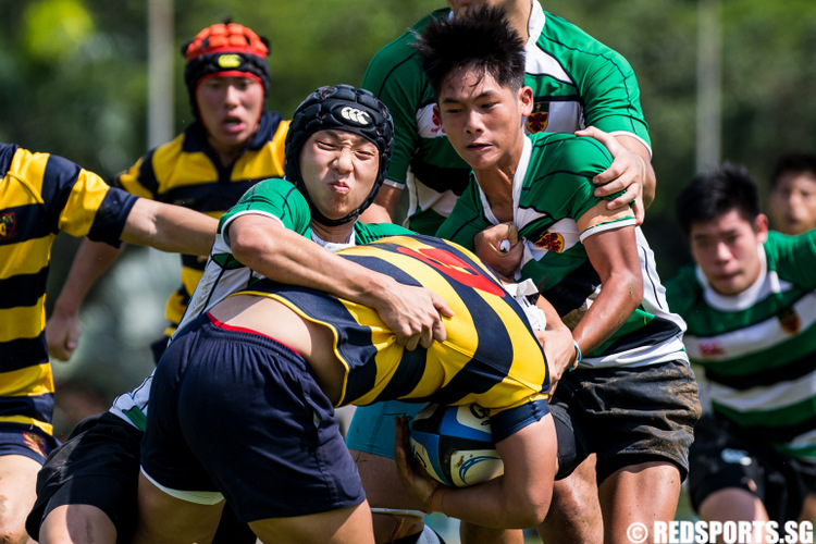(#9) and (#22) of Raffles Institution tackle Kyler Wong (#9) of Anglo-Chinese School (Independent). (Photo © Lim Yong Teck/Red Sports)