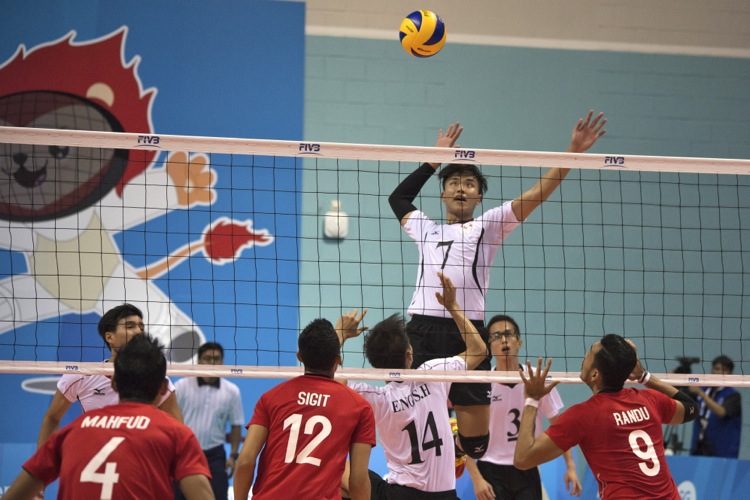 Benjamin Choo Wei Jie (#7) is set up for a spike as he rises above the net for an overhead attacking shot.