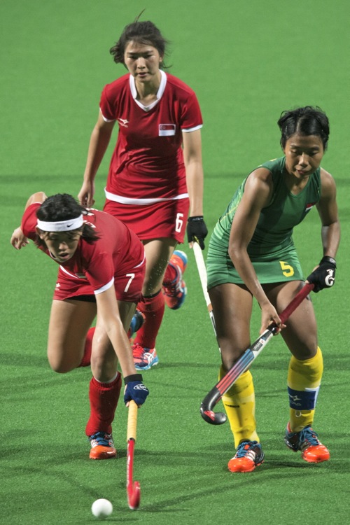 Singapore’s Tiffany Ong (#6) and Emily Chan (#7) tussling for the ball.  Singapore had more possession of the ball in a hard fought match against Indonesia. 