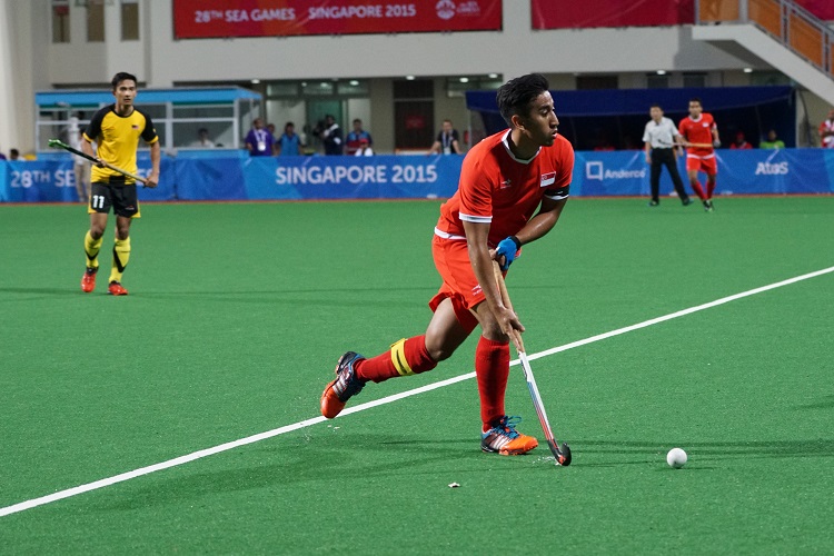A Singapore player presses forward with the ball. 