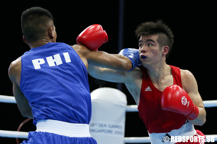 Tay Jia Wei (Red) of Singapore and Eumir Felix Marcial (Blue) of Philippines in action during the Men's Welterweight (69kg) Finals. (Photo © Lee Jian Wei/Red Sports)