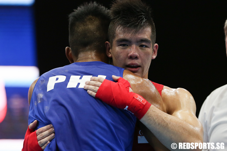 Tay Jia Wei (Red) of Singapore and Eumir Felix Marcial (Blue) of Philippines share a moment after the match. (Photo © Lee Jian Wei/Red Sports)