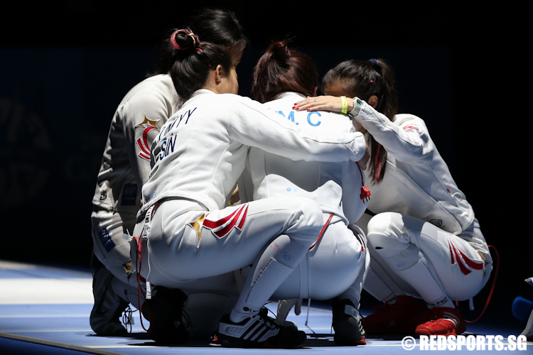 Teammates Rania, Victoria and Elizabeth console Cheryl after losing to Philippines 29–28 in the Women's Team Epee semi-finals. The team settled for the bronze medal. (Photo © Lee Jian Wei/Red Sports)