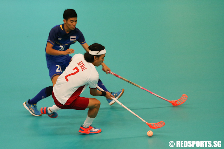 Akmal Shaharudin (#2) of Singapore and Monthon Prakotchue (#20) of Thailand fight for possession of the ball. (Photo © Lee Jian Wei/Red Sports)