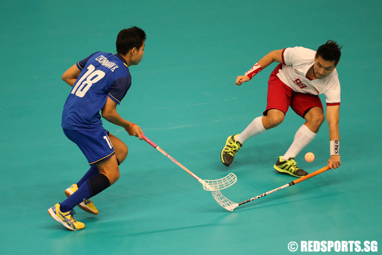 Brandon Cheong (#99) of Singapore stops Chonnakan Kruarod (#18) of Thailand from breaking through the defence. (Photo © Lee Jian Wei/Red Sports)