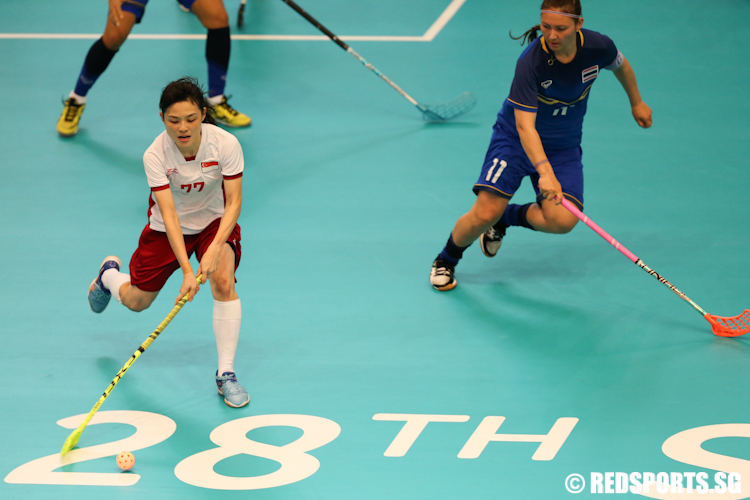 Lai Soak Kuan (#77) of Singapore dribbles the ball against Thailand's defence. (Photo © Lee Jian Wei/Red Sports)