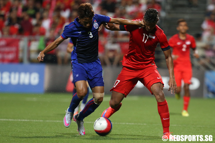 Irfan Fandi (#17) of Singapore and Nen Sothearoth fight for possession of the ball. (Photo © Lee Jian Wei/Red Sports)