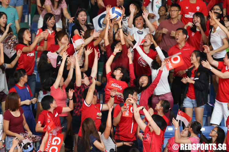 Crowd catching the official match ball signed by Singapore captain Micky Lin. (Photo © Lee Jian Wei/Red Sports)