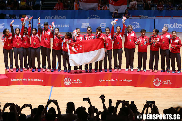 Team Singapore on the podium after receiving the gold medal. (Photo © Lee Jian Wei/Red Sports)
