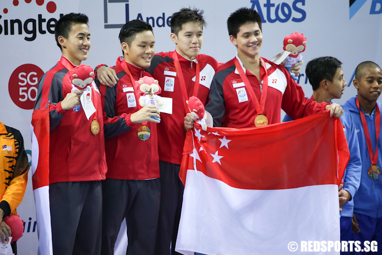 (L-R) Quah Zheng Wen, Pang Sheng Jun, Danny Yeo and Joseph Schooling pose for a photo after clinching gold in the Men's 4x200m Freestyle event. They set new Games and national records with a time of 7 minutes and 18.14 seconds. (Photo © Lee Jian Wei/Red Sports)