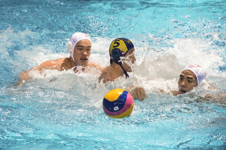 Eugene Teo (#4) and Bryan Ong (#5) win back the ball by crowding out their opponent.