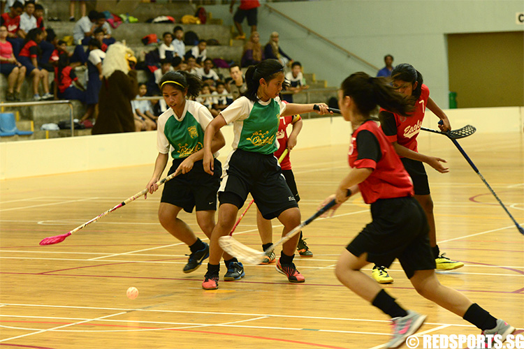 Patricia Mae Britania (OP #10) looks to maintain control of the ball while teammate Nurul Izzah Bte Dzulkifli (#2) seeks to keep their opponents away. (Photo 5 © Louisa Goh/Red Sports)