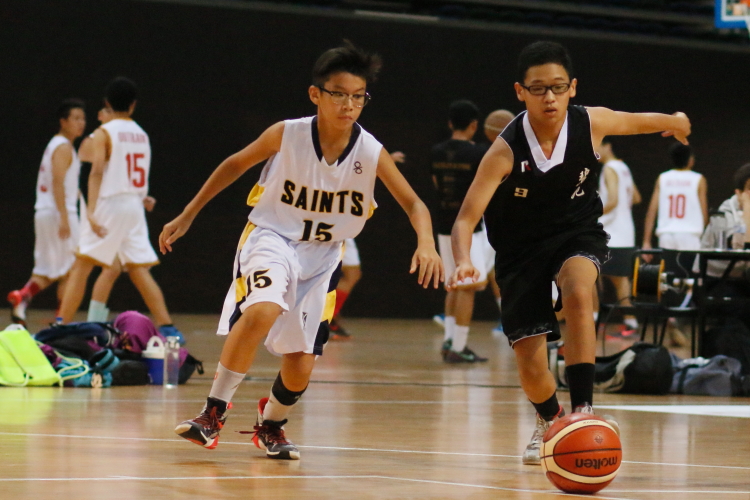 #15 of SAS and Joshua Poh Zi Xuan (BPS #9) hustling for a loose ball.