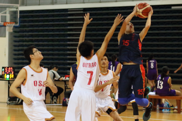 Wallace (ACS Barker #15) soaring for a layup over Outram's defense. Wallace had 12 points in the game.