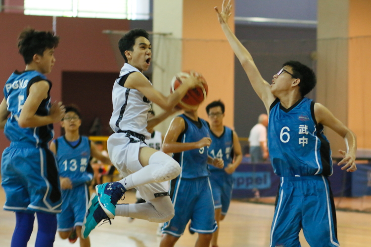 Ethan (Unity #7) hanging in the air as he attempts a layup over the Bukit Panjang defense. 