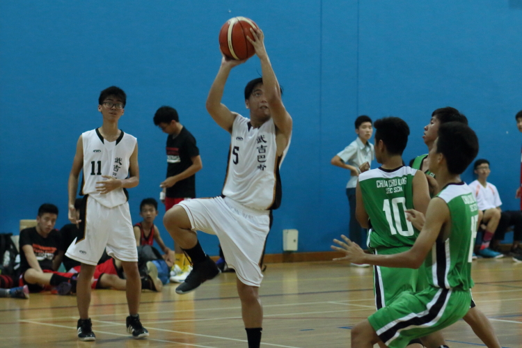 Kevin Enton Yang (BBS #5) taking a shot over the CCK defense. He was one of the 3 BBS players who scored in double digits with  11 points.