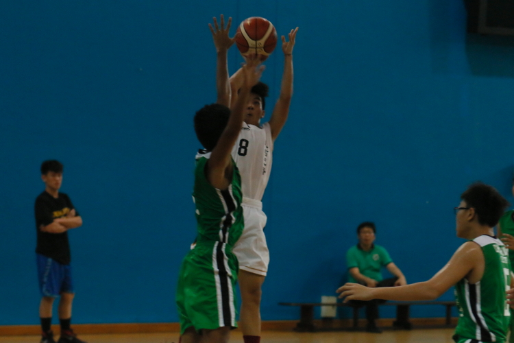 Le Ngoc Do (BBS #8) taking a tough contested jumpshot over his defender.