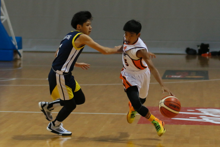 Pit (Mayflower #5) slashing past his defender. He scored a team-high 13 points.