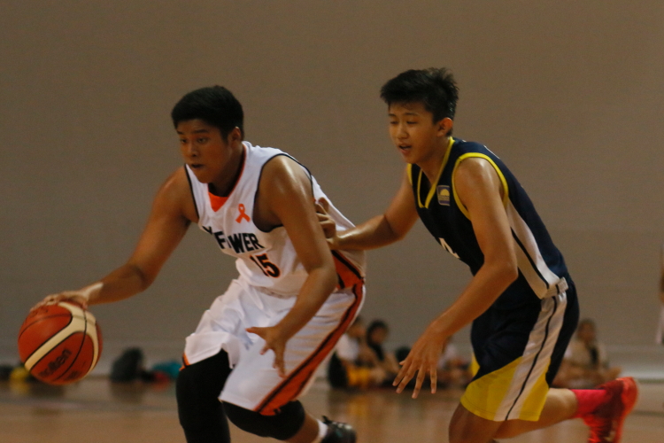 Nicko (Mayflower #15) driving past his defender to the hoop.