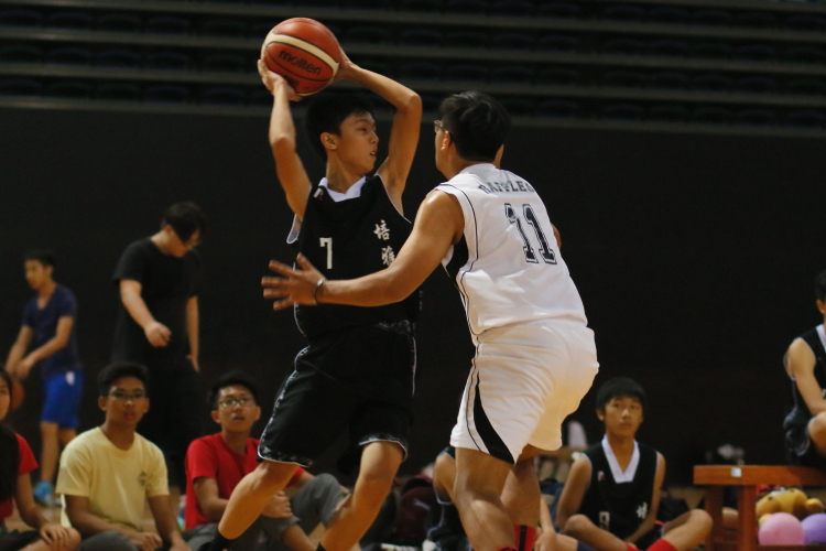 Biao Yang (Pierce #7) looking to pass over the tight defense of Adam Harith (Raffles #11).