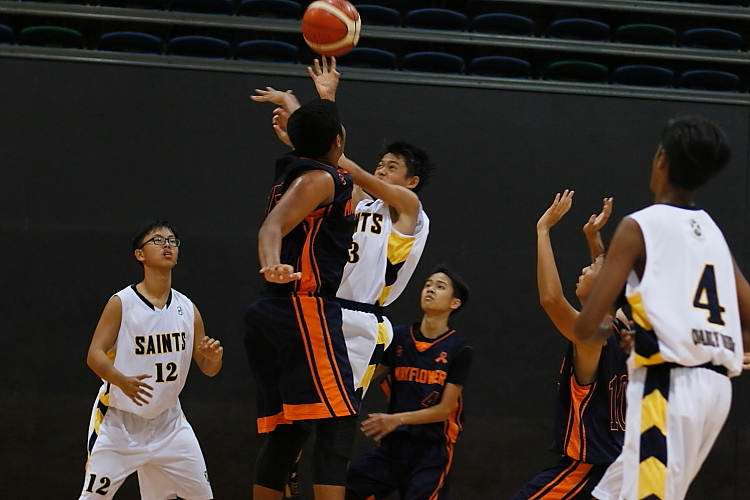 Jia Sing (SA #13) takes a floater over the outstretched arms of his defender. (Photo  © REDintern Chan Hua Zheng)