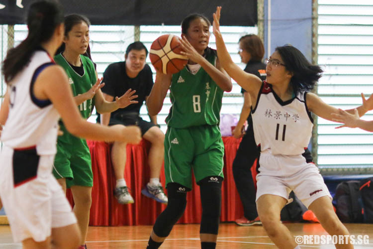 Gladys Ng Hui En (Christ Church #8) looks for her teammate while Wee Xin Yi (Woodgrove#11) plays defence. Gladys scored 8 points in the game while Xin Yi scored 7.  (Photo 3 © REDintern Chua Kai Yun)