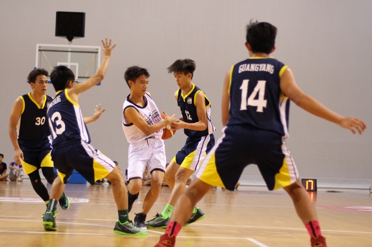 Gerald (Guangyang #12) steals the ball from Ian Tay (NJC #10). (Photo 3 © REDintern Adeline Lee)