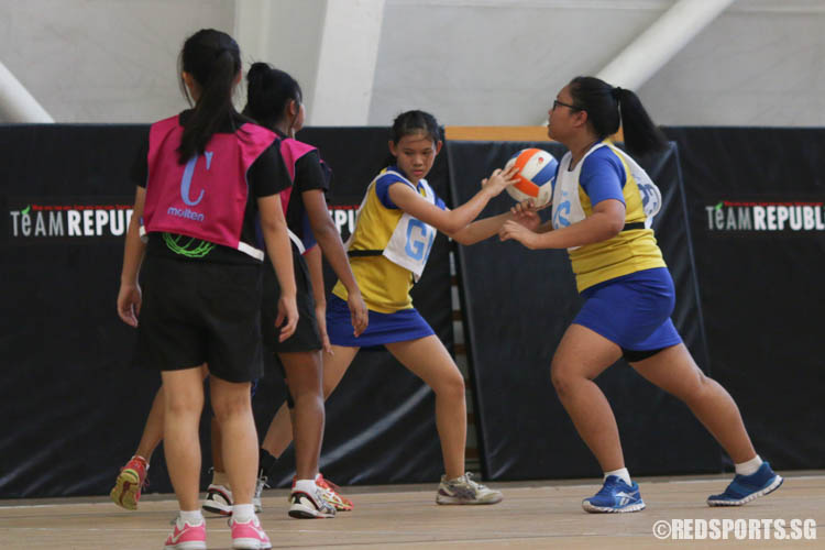 GA of Woodlands guards the ball against her opponents. (Photo 2 © REDintern Chua Kai Yun)