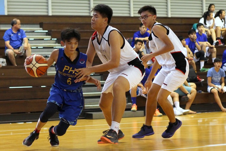 (PHS #6) drives in strong against his defenders for a layup. (Photo 2 © REDintern Adeline Lee)