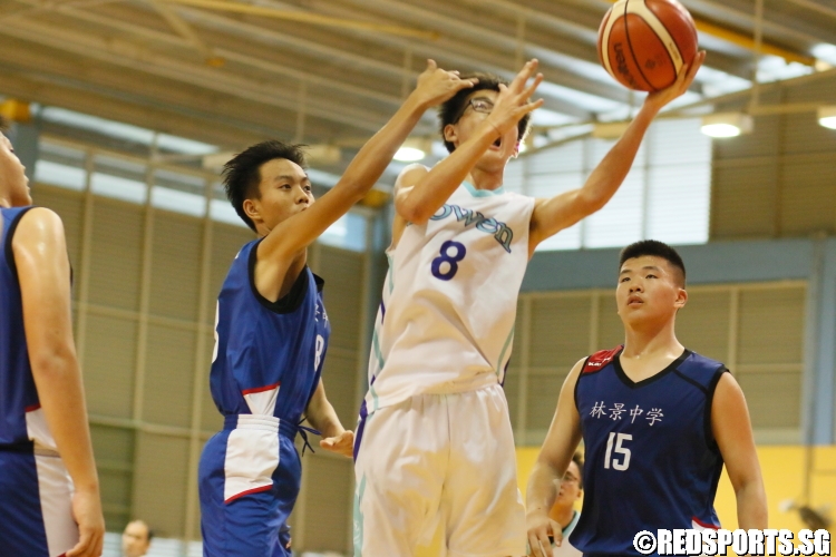 Nicholas Liew (Bowen #8) avoiding the defense mid-air as he attempts a layup. He scored a team-high 21 points in the double overtime thriller. (Photo  © Chan Hua Zheng/Red Sports)