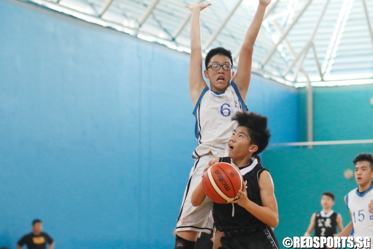 Justin Lee (CHS #1) gets his opponent up in the air with a ball fake. (Photo 5 © Dylan Chua/Red Sports)