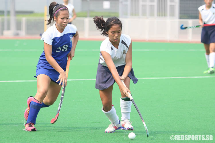 Phylicia Tanandika (SNG #11) dribbles the ball against Jolene Ng (STC #38). (Photo © Chua Kai Yun/Red Sports)