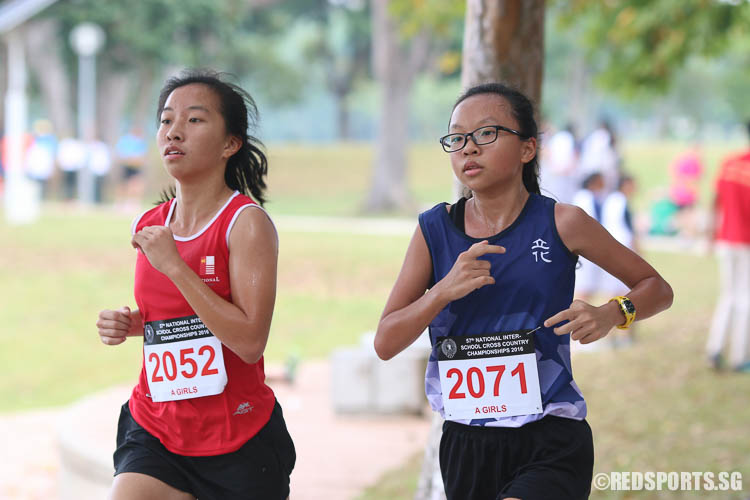 Tay Jin Wen (#2052) of NJC and Melanie Hui (#2071) of RVHS running in the 3.65km route under the A Division Girls category. Tay finished sixteenth with a timing of 16:29.24, while Hui finished seventeenth with a timing of 16:30.11. (Photo © Chua Kai Yun/Red Sports)