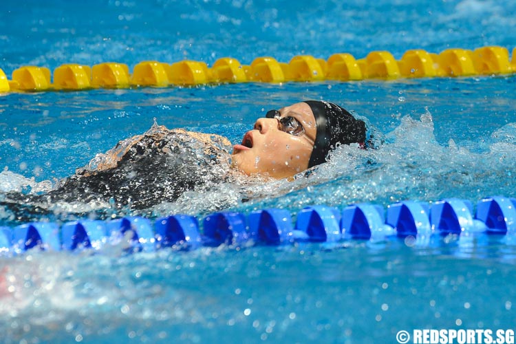Christie Chue in action during the women's 13 and over 200m IM prelims backstroke leg at the 47th Singapore National Age Group Swimming Championships. (Photo © Soh Jun Wei/Red Sports)