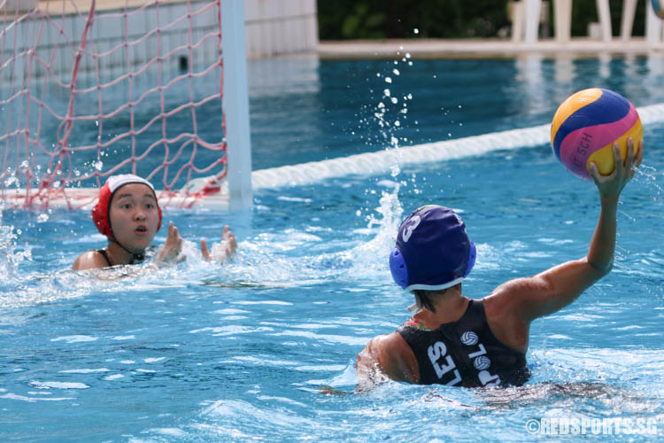 Tricia Tan (#3) of Raffles Institution fires a lob shot. She scored 8 goals for her team. (Photo 3 © Chua Kai Yun/Red Sports)