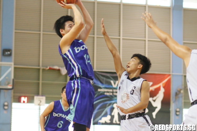 Wilbur Tan (Bowen #14) rises up for a jumpshot over the defense. He finished with a team-high 15 points. (Photo  © Chan Hua Zheng/Red Sports)